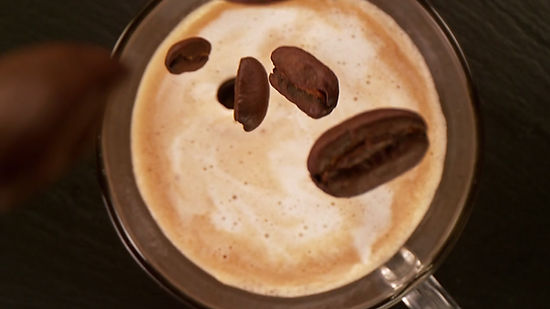 Camera motion, falling coffee beans into coffee cup